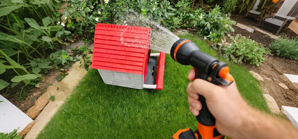 Easy-to-clean waterproof plastic design of Difsight nesting house being washed with a garden hose for hygiene